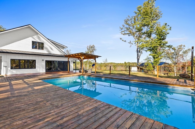 view of swimming pool with a wooden deck