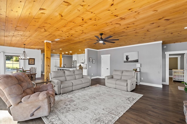 living room with dark wood-type flooring, wood ceiling, crown molding, and ceiling fan with notable chandelier