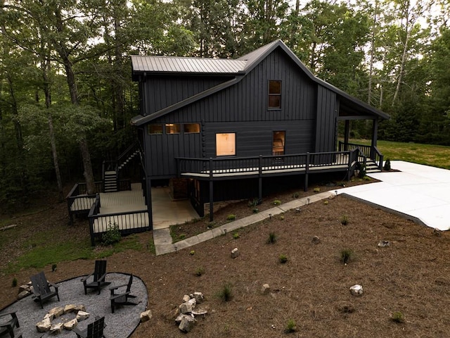 365 Browns Cove Rd, Blue Ridge, GA 30513 - modern inspired farmhouse featuring an outdoor fire pit, board and batten siding, stairway, a wooden deck, and a patio