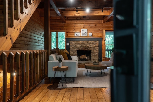 365 Browns Cove Rd, Blue Ridge, GA 30513 - sitting room with hardwood / wood-style floors, beam ceiling, wooden walls, and a fireplace