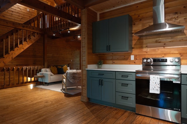 365 Browns Cove Rd, Blue Ridge, GA 30513 - kitchen with stainless steel range with electric cooktop, wall chimney exhaust hood, light wood-style flooring, light countertops, and wooden walls