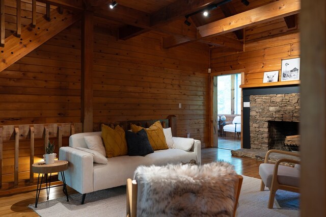 365 Browns Cove Rd, Blue Ridge, GA 30513 - living room with wood walls, rail lighting, wooden ceiling, hardwood / wood-style floors, and a fireplace