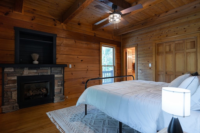 365 Browns Cove Rd, Blue Ridge, GA 30513 - bedroom featuring wood ceiling with exposed beams, wood walls, a fireplace, wood finished floors, and ceiling fan