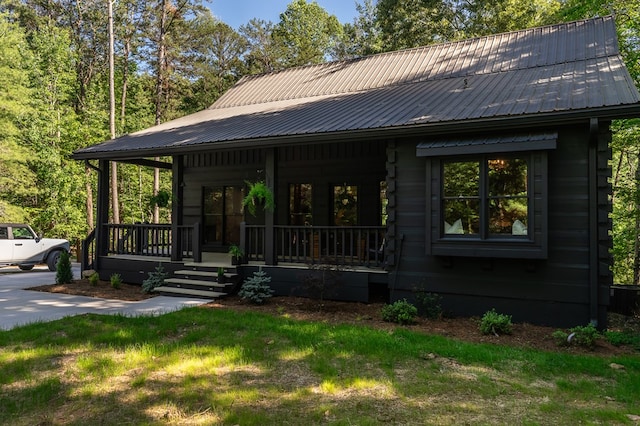 365 Browns Cove Rd, Blue Ridge, GA 30513 - view of front of home with covered porch, metal roof, a front lawn, and log siding