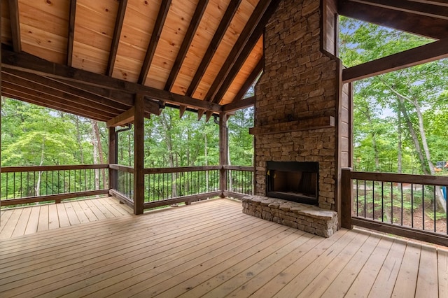 wooden terrace with a stone fireplace