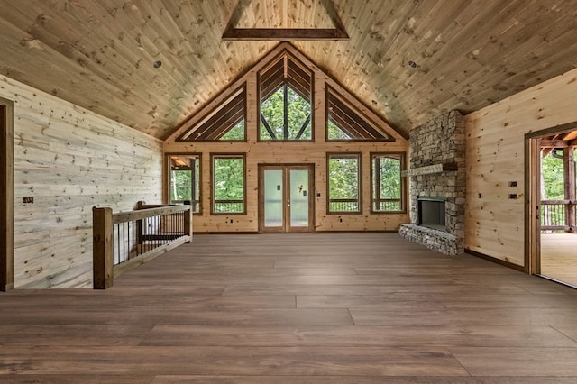 unfurnished living room featuring hardwood / wood-style flooring, wood ceiling, a fireplace, and high vaulted ceiling