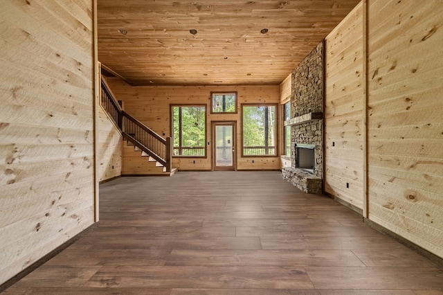 unfurnished living room featuring wooden ceiling, a fireplace, stairs, and hardwood / wood-style flooring