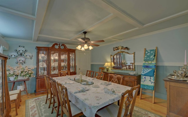 dining room featuring light wood-type flooring, ceiling fan, and crown molding