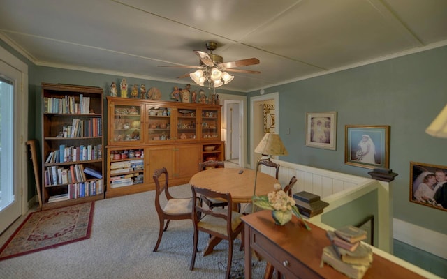 dining space with carpet floors, crown molding, plenty of natural light, and ceiling fan