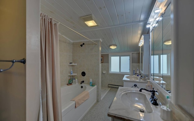 bathroom with vanity, vaulted ceiling, baseboard heating, shower / bath combo with shower curtain, and tile walls