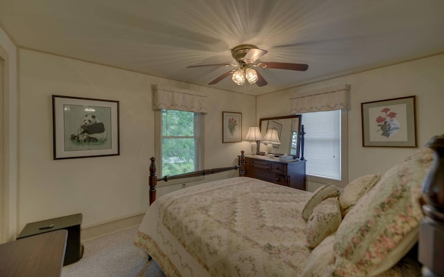 bedroom featuring ceiling fan and light carpet