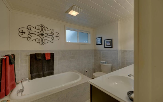 bathroom with a bath, vanity, toilet, and tile walls