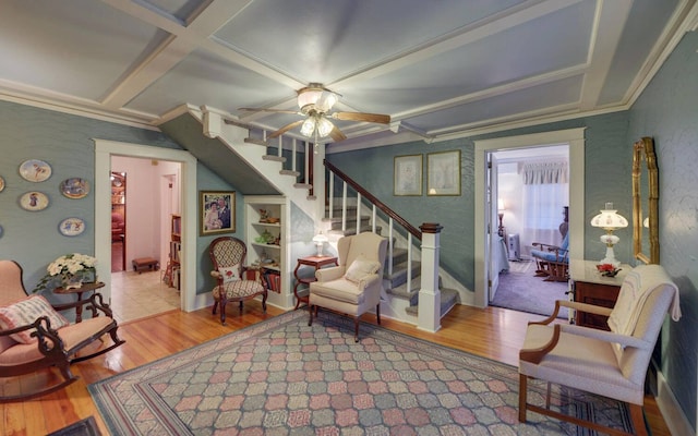 sitting room featuring beamed ceiling, wood-type flooring, ceiling fan, and coffered ceiling