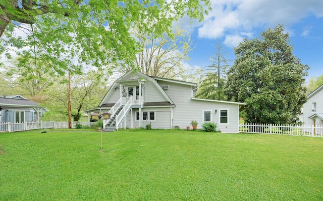 rear view of house featuring a lawn