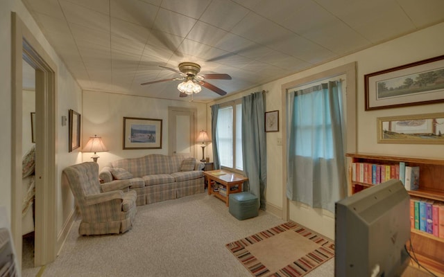 sitting room with ceiling fan and light carpet