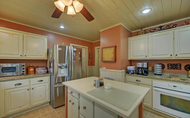 kitchen featuring appliances with stainless steel finishes, a center island, ceiling fan, and wood ceiling