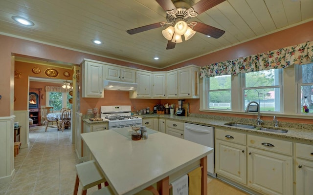 kitchen featuring a kitchen island, white appliances, sink, and wooden ceiling