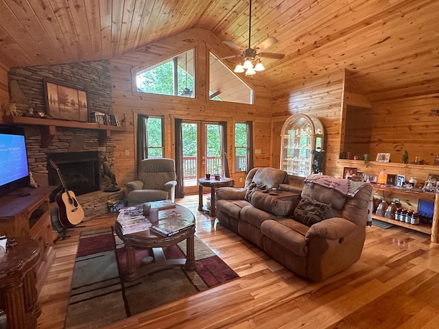 living room featuring wood walls, plenty of natural light, wood finished floors, and wood ceiling