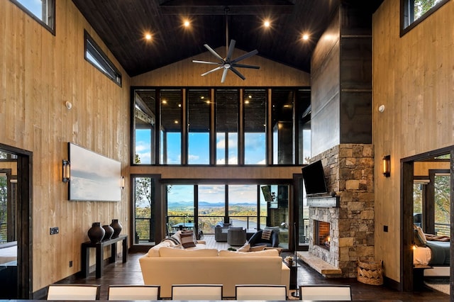 living room with ceiling fan and high vaulted ceiling