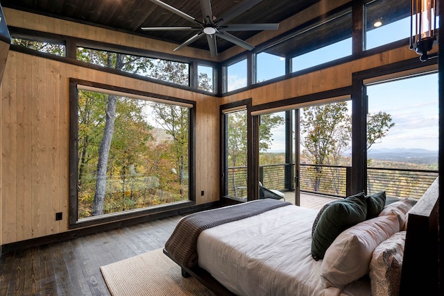 bedroom featuring wooden walls and dark wood-style floors