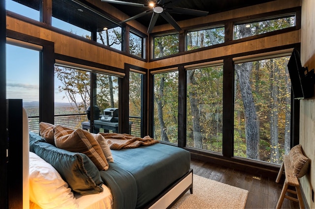 bedroom featuring a water view and hardwood / wood-style flooring