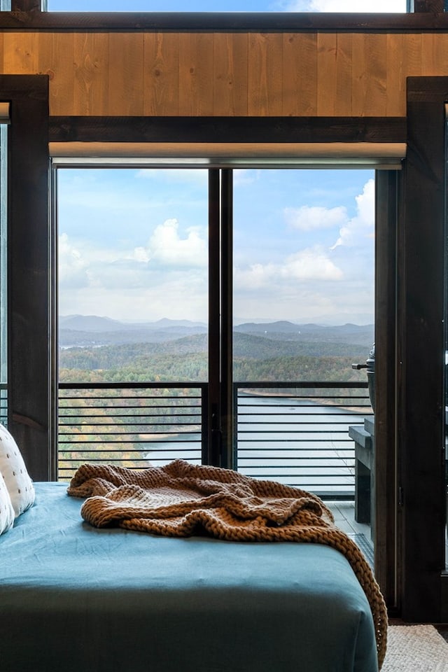 bedroom with a mountain view and multiple windows