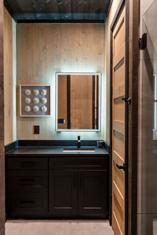 bathroom with wooden walls and vanity