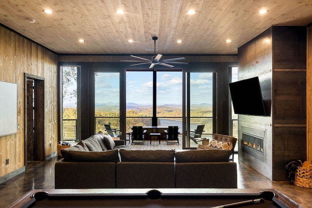 living room featuring wood walls, recessed lighting, and wooden ceiling