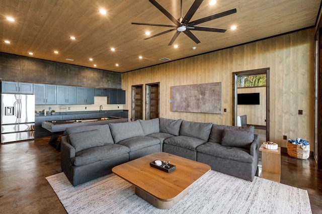 living area featuring concrete floors, wood ceiling, and recessed lighting