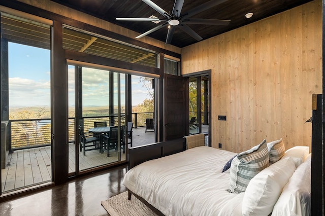 bedroom featuring wooden ceiling, wooden walls, wood finished floors, and access to exterior