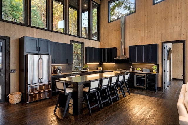 kitchen featuring a wealth of natural light, high end fridge, and a high ceiling