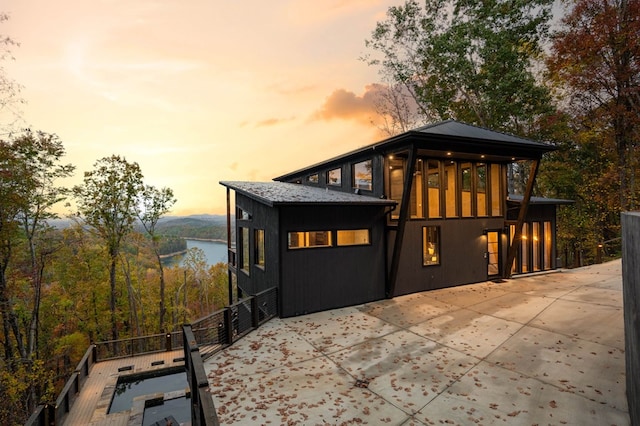 exterior space featuring a water view and a patio area