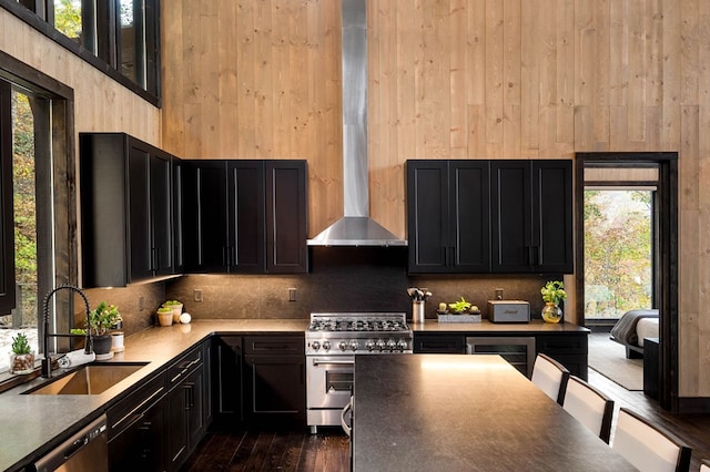 kitchen with beverage cooler, stainless steel appliances, a healthy amount of sunlight, and a sink