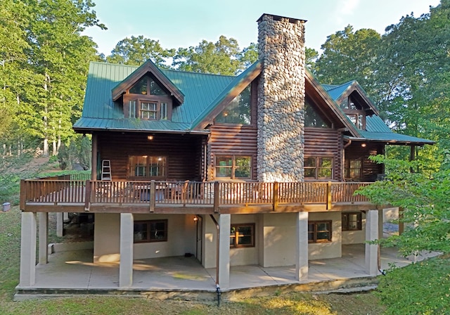 back of house featuring a deck and a patio area