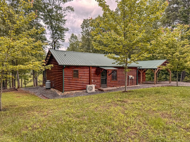 log-style house with a front lawn and metal roof
