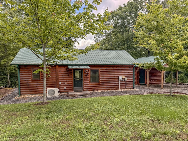 view of front of house featuring a front lawn, a cooling unit, and metal roof