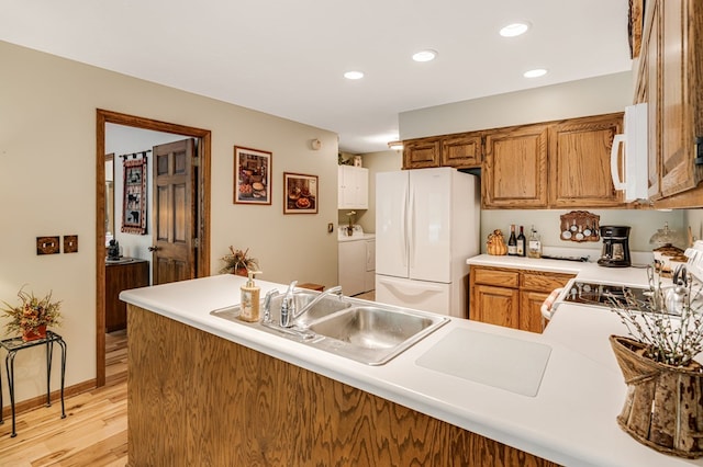 177 Lake Dr, Topton, NC 28781 - kitchen featuring white appliances, washer and clothes dryer, light wood-type flooring, a sink, and light countertops