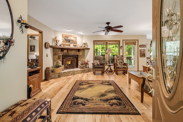 177 Lake Dr, Topton, NC 28781 - living area featuring a ceiling fan, a stone fireplace, and hardwood / wood-style floors