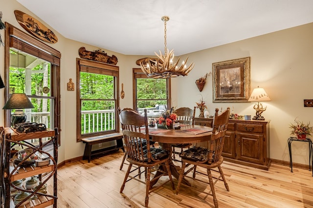 177 Lake Dr, Topton, NC 28781 - dining space featuring a chandelier, light wood-style flooring, and baseboards