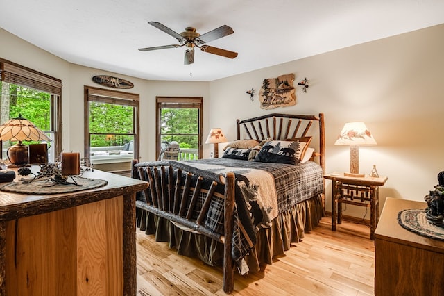 177 Lake Dr, Topton, NC 28781 - bedroom with multiple windows, light wood finished floors, and ceiling fan