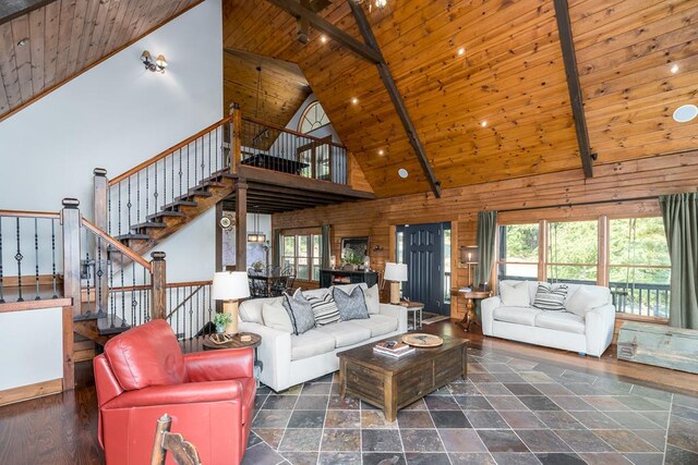 unfurnished living room with wooden ceiling, beam ceiling, high vaulted ceiling, and dark hardwood / wood-style flooring