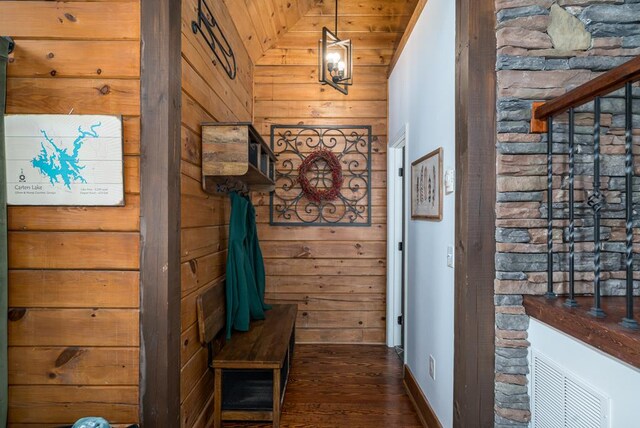 corridor featuring dark hardwood / wood-style floors, wooden walls, wooden ceiling, and vaulted ceiling