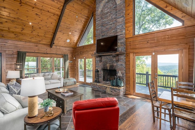 1363 NE Foxhound Trl, Ranger, GA 30734 - living room featuring high vaulted ceiling, wooden walls, a fireplace, french doors, and wooden ceiling with exposed beams