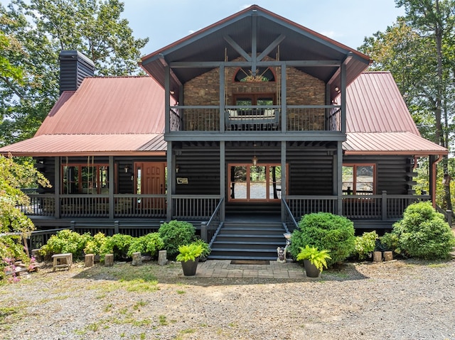 1363 NE Foxhound Trl, Ranger, GA 30734 - view of front of property featuring a balcony, metal roof, a chimney, a porch, and log exterior