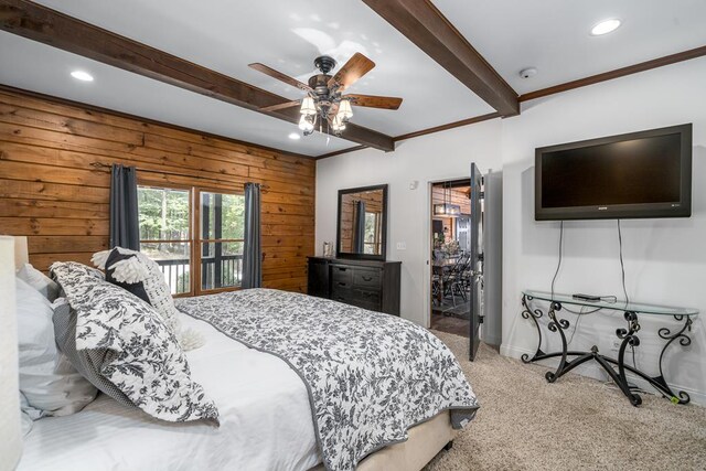 bedroom featuring wood walls, ceiling fan, light carpet, beam ceiling, and ornamental molding