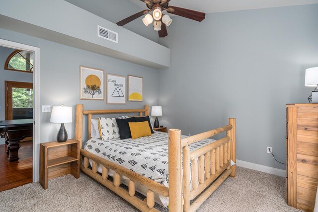 bedroom featuring ceiling fan, light carpet, and lofted ceiling