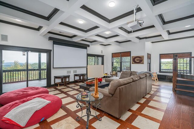 home theater featuring beam ceiling, a healthy amount of sunlight, and coffered ceiling