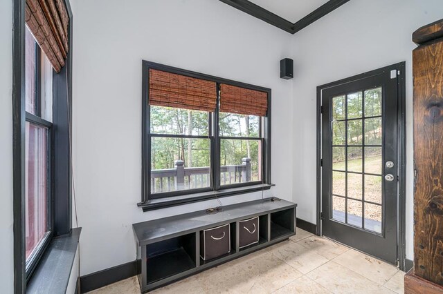 interior space with a wealth of natural light, ornamental molding, and light tile patterned flooring