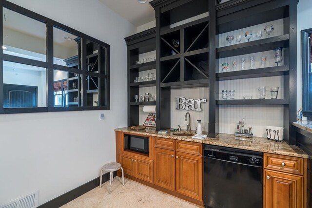 bar featuring black appliances, sink, and light stone counters