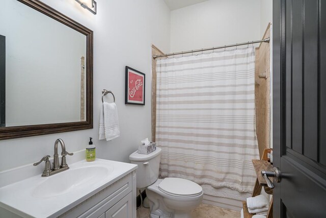 bathroom with toilet, walk in shower, and vanity